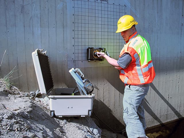 Professional technician performing GPR concrete scanning with advanced ground-penetrating radar equipment at construction site in Dubai